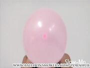 Teen blows up pink balloons in bikini