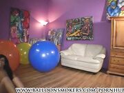 Teen jumps and falls on big balloons