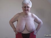 Grey granny plays with huge tits