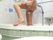 Redhead babe cums with her favorite toy after a shower.