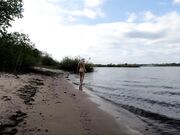 Exhibitionist Blonde Goes Nude on a River Beach