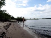 Exhibitionist Blonde Goes Nude on a River Beach