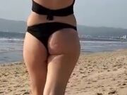 Daniela Duran in a bikini at a beach making out with kissing a random guy