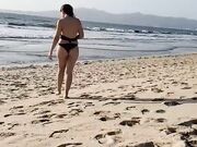 Daniela Duran in a bikini at a beach making out with kissing a random guy