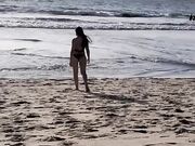 Daniela Duran in a bikini at a beach making out with kissing a random guy