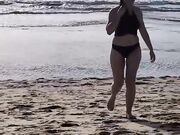 Daniela Duran in a bikini at a beach making out with kissing a random guy