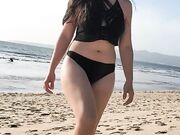 Daniela Duran in a bikini at a beach making out with kissing a random guy